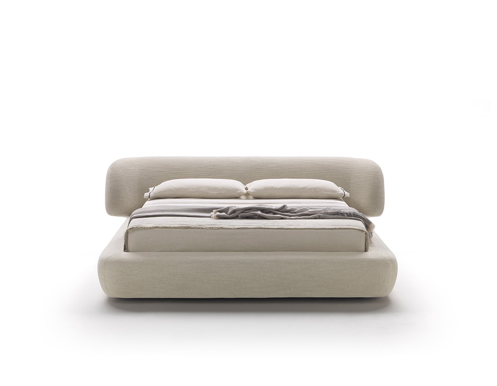bed made of wood, polyurethane foam and removable leather in different light tones on a white background