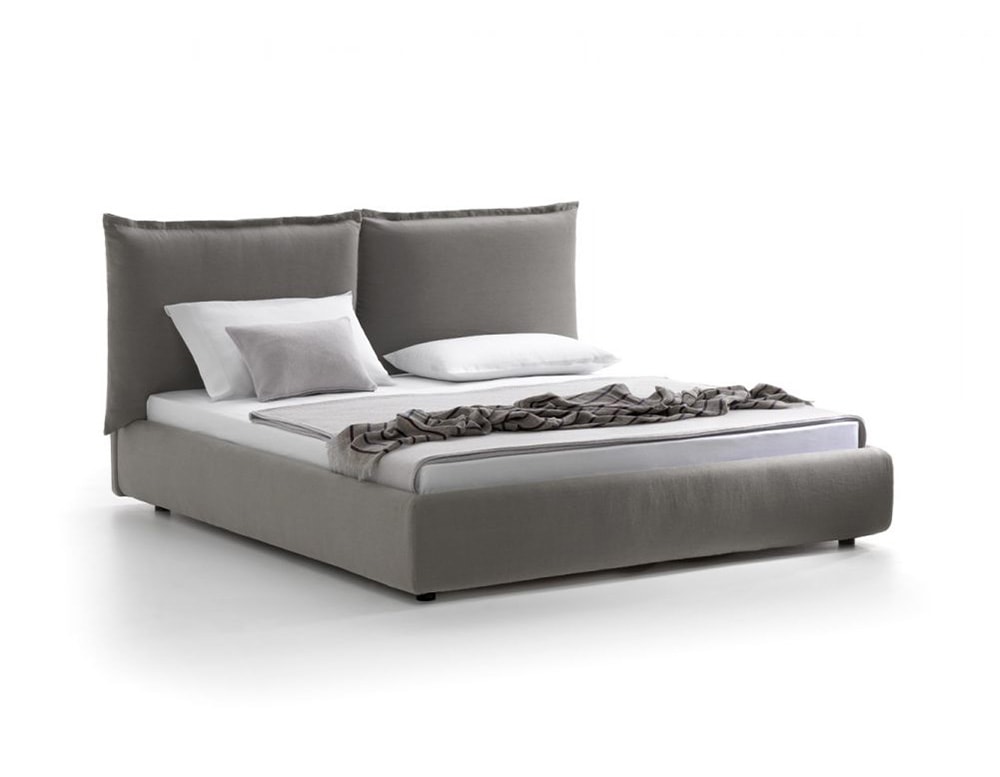 bed with headboard divided into two large cushions made of fabric and wood in a light gray tone