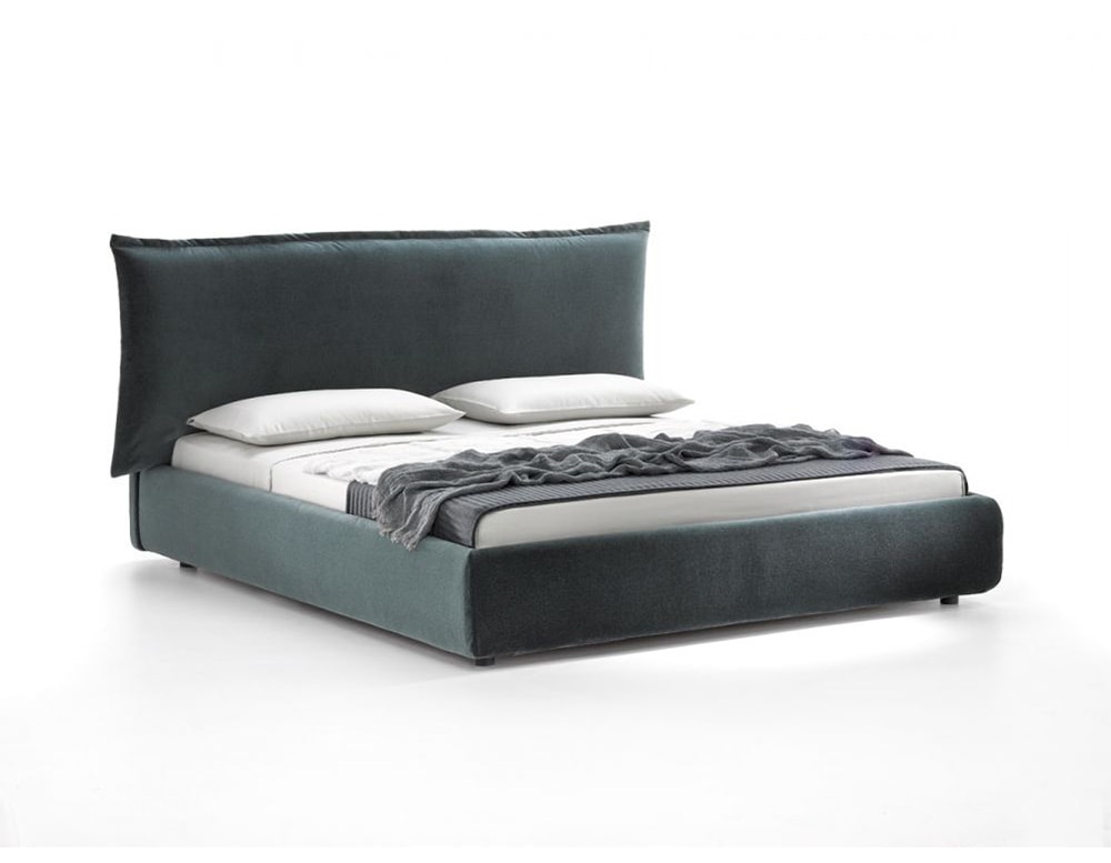 bed with high cushion backrest and wooden base all upholstered in emerald green fabric on a white background