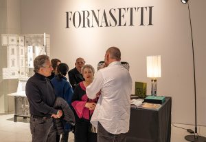 A captivating moment at the Fornasetti exhibition, where guests engage with the brand’s iconic designs, blending art, history, and craftsmanship.