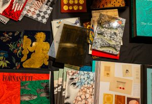 A vibrant collection of Fornasetti-inspired designs, showcasing intricate patterns, artistic prints, and rich textures that celebrate timeless craftsmanship and creativity.