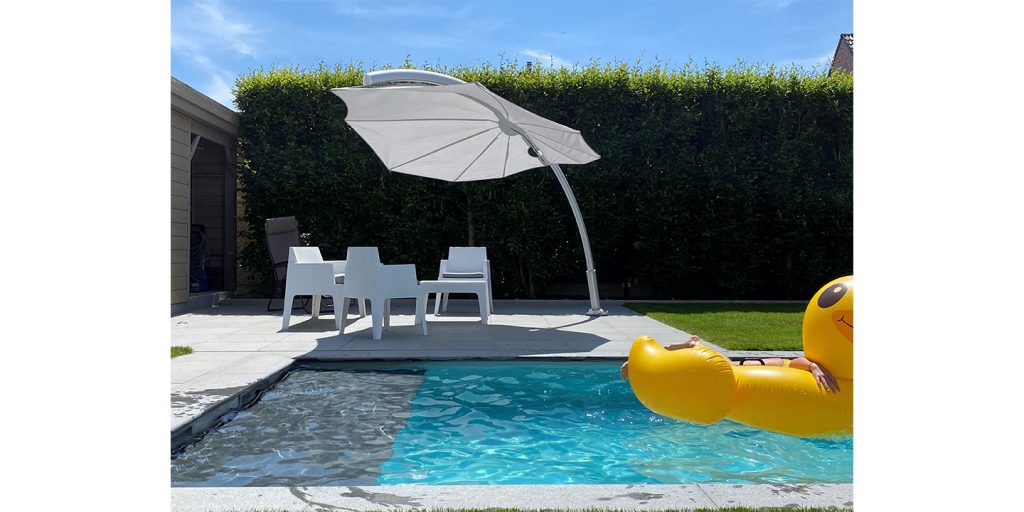 White octagon-shaped umbrella made of fabric and metal in a pool