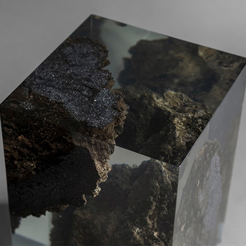 stool made with lava stone dipped in resin preserving dark colors such as black and gray