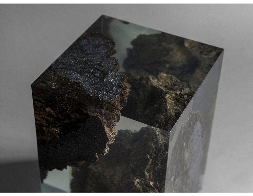 stool made with lava stone dipped in resin preserving dark colors such as black and gray