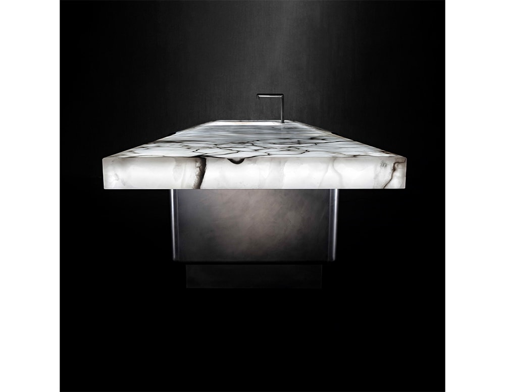 counter made of white stone with cracked finishes in a black background