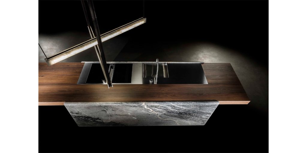kitchen counter made of dark brown wood, white stone and metal