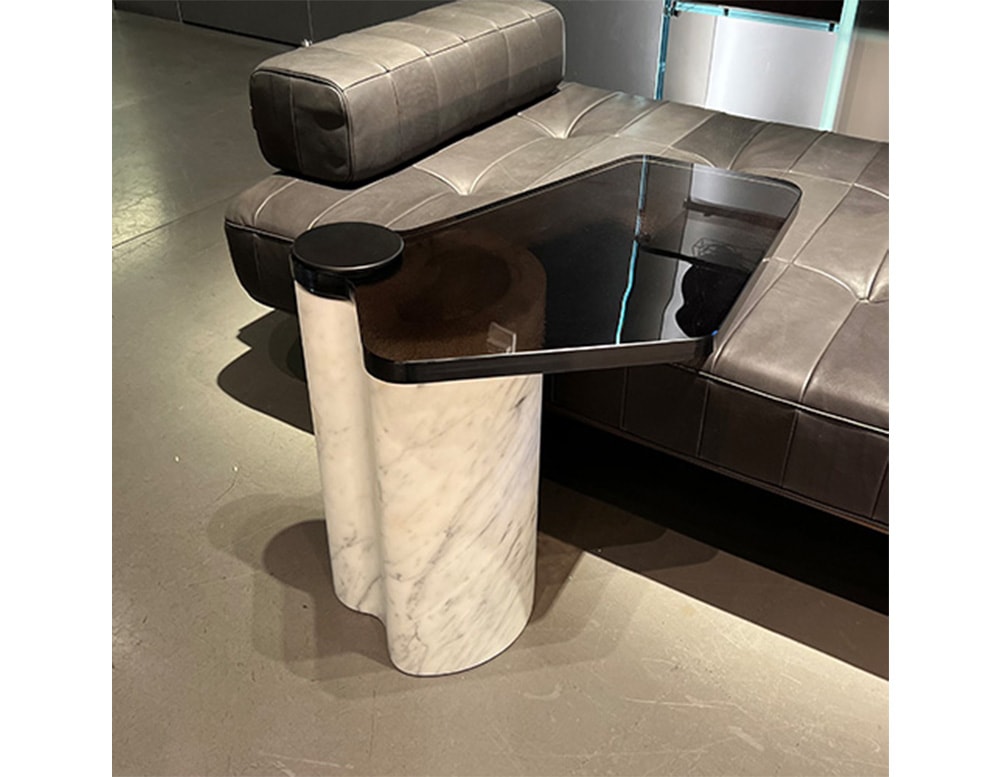 side table made with white stone base and rotating top in black glass or metal
