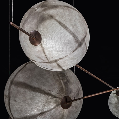 Three white fiberglass spheres of varying sizes