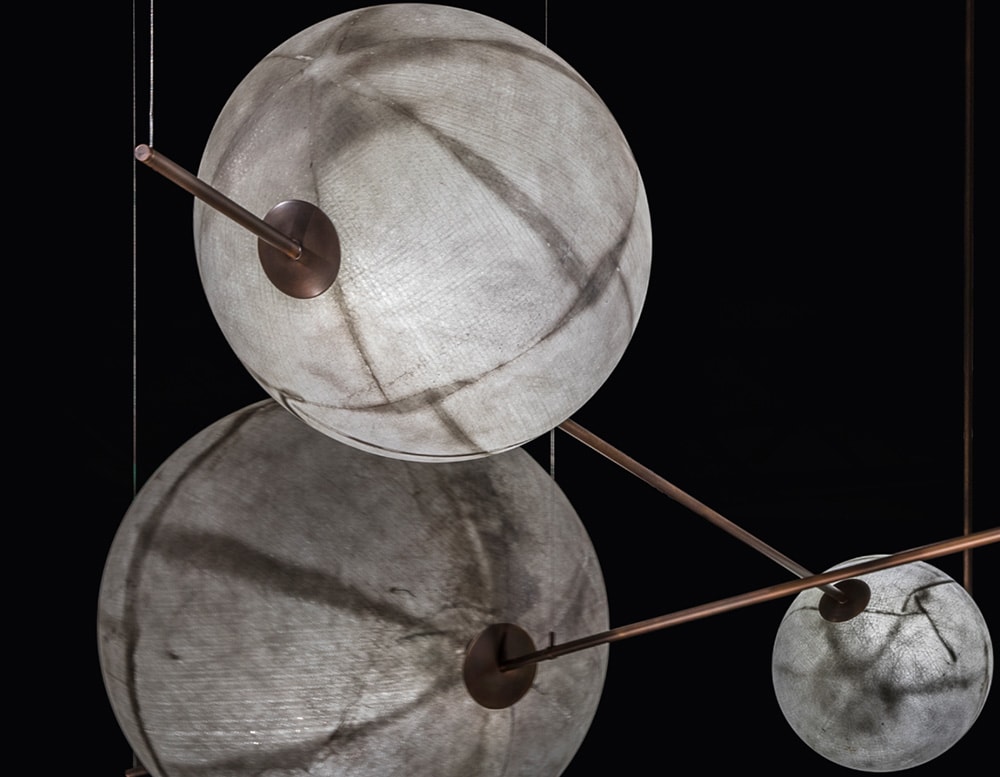 sphere shaped lamps made of fiberglass and with brass and metal stems in white and gold tones