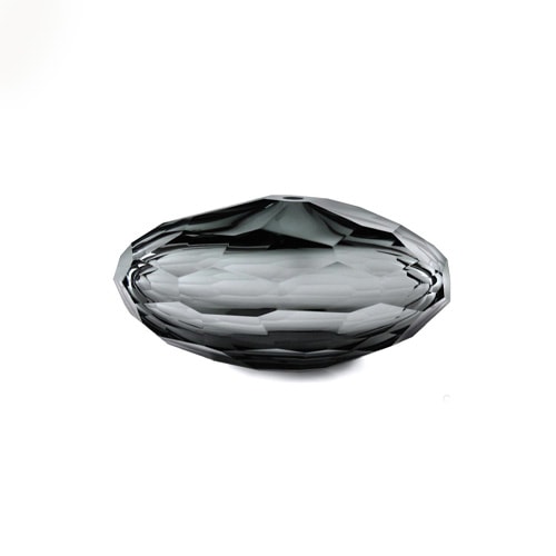 transparent black glass sculpture with an oval shape and pentagon-shaped finishes