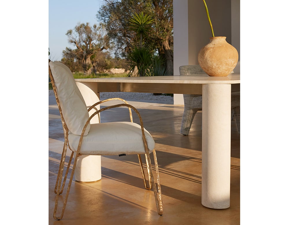 Outdoor chair made with a base made of gold aluminum and upholstered in white and finishes