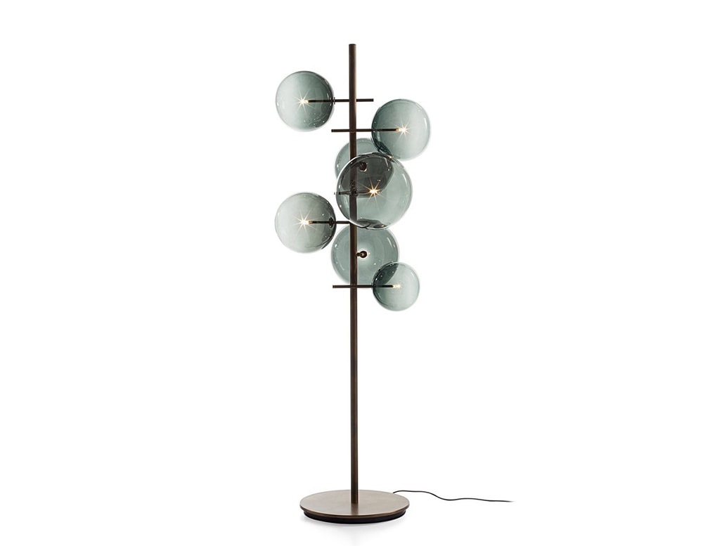 Floor lamp with 7 clear gray blown glass spheres on a white background