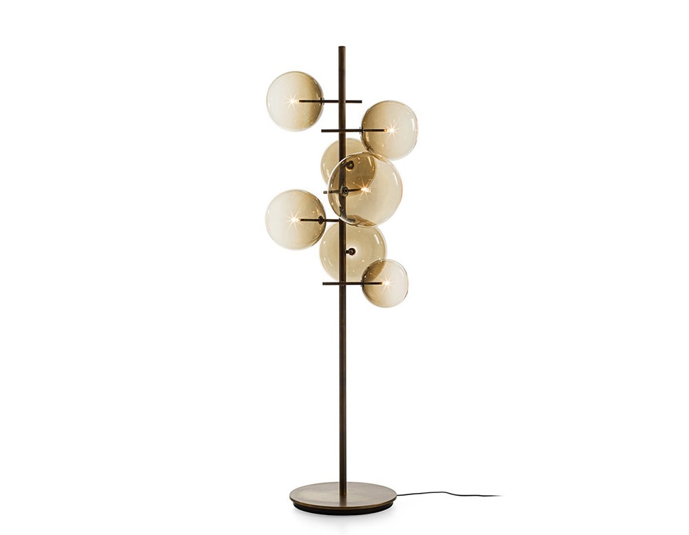 Floor lamp with 7 clear yellow blown glass spheres on a white background
