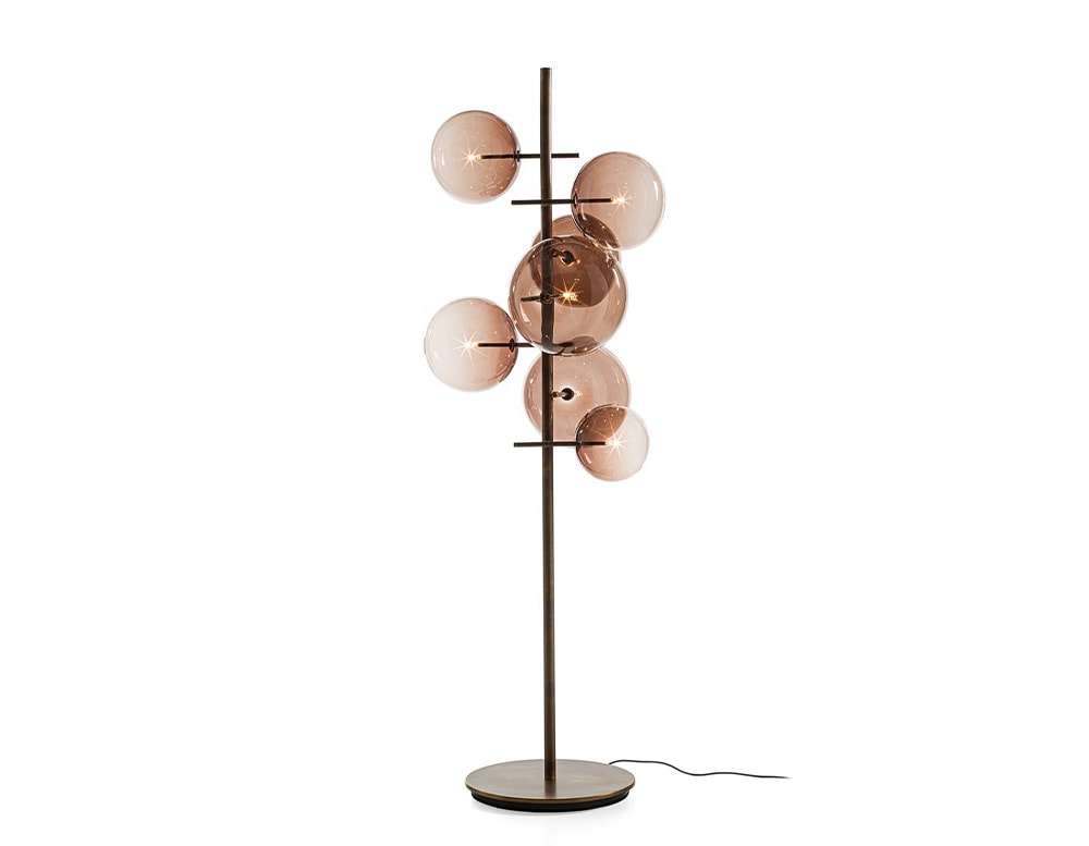 Floor lamp with 7 clear red blown glass spheres on a white background