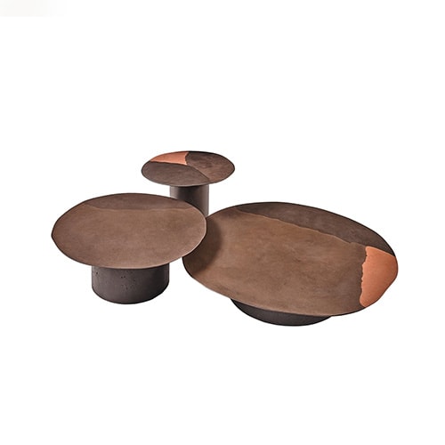 Three brown circular coffee tables in recycled glass, the surface is not flat