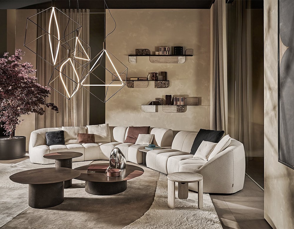 Three brown circular coffee tables in recycled glass, in a living room beside a beige sectional