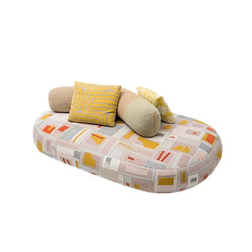 A playful sofa with rounded form and bold patterned upholstery enhanced by soft colorful cushions that bring charm and comfort to modern living spaces.