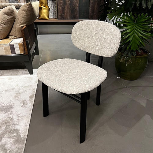 chair upholstered in white fabric and black wooden base