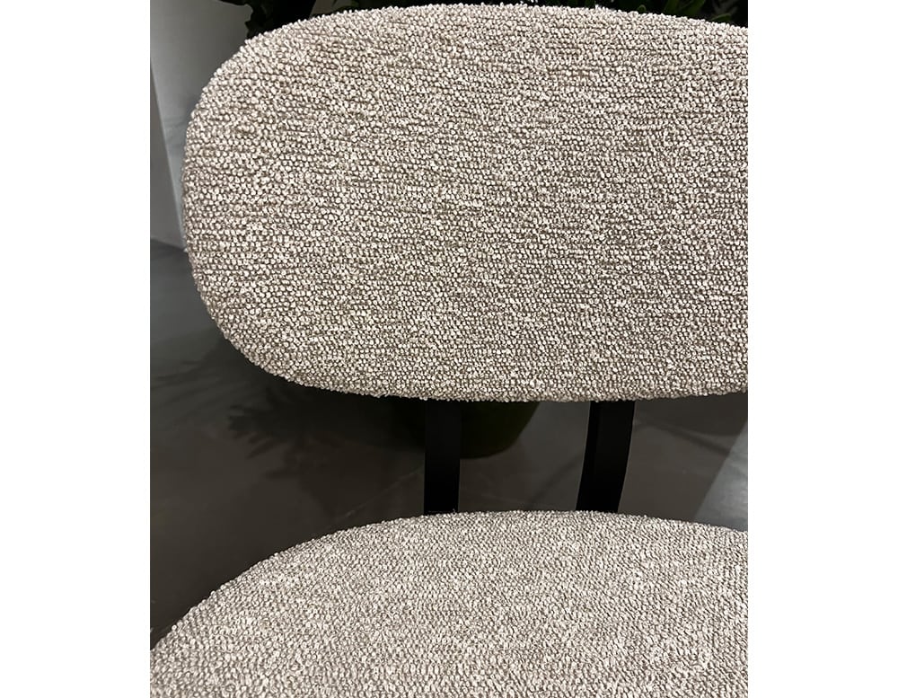 chair upholstered with white fabric and finishes with a shiny texture.