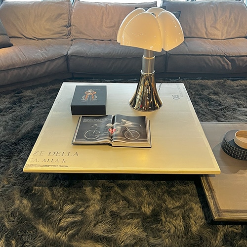 Coffee table with satin-finished round metal bar base, wooden table top covered in resin, and silk-screened by hand in beige