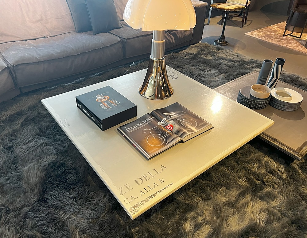 Two coffee tables with satin-finished round metal bar base, wooden table top covered in resin, and silk-screened by hand in beige