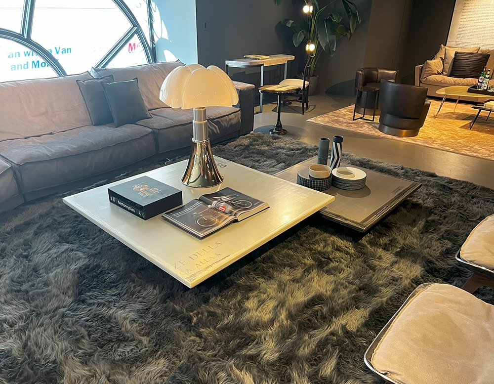 Two coffee tables with satin-finished round metal bar base, wooden table top covered in resin, and silk-screened by hand in beige and grey color
