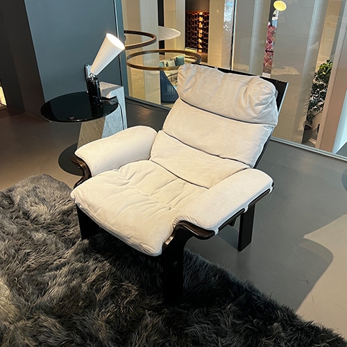 Dark brown wooden armchair with an iced gray suede finish