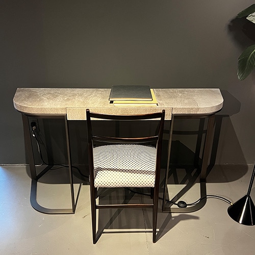 handmade black steel and beige leather desk in a living room.