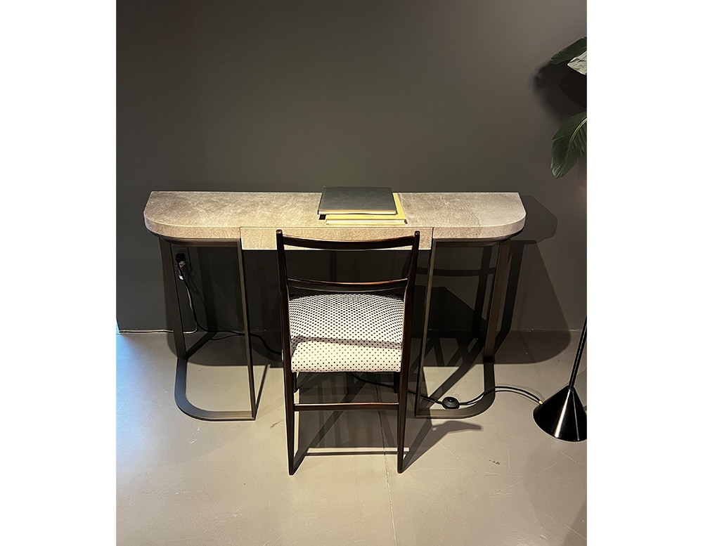 small handmade desk made of burnished metal and upholstered in Bohemian Khaki leather with different shades of black and beige.