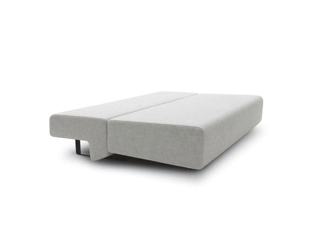 Piece of seating furniture which also serves as a bed in beige color fabric