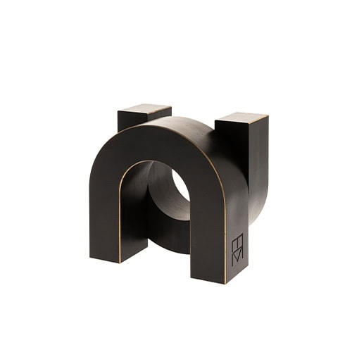 Sculptural accent in solid black with a bold arched form and subtle golden edges designed to stand as a statement accessory or architectural object in modern interiors.