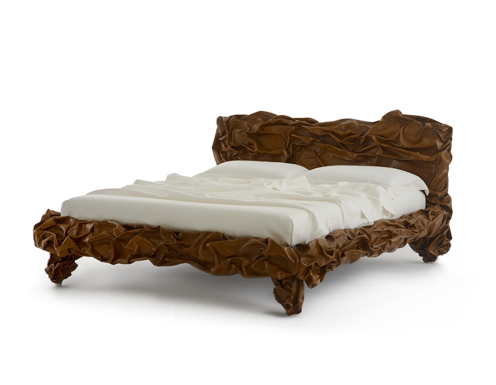 Handmade bed covered in brown leather and metal base covered by leather in a white background