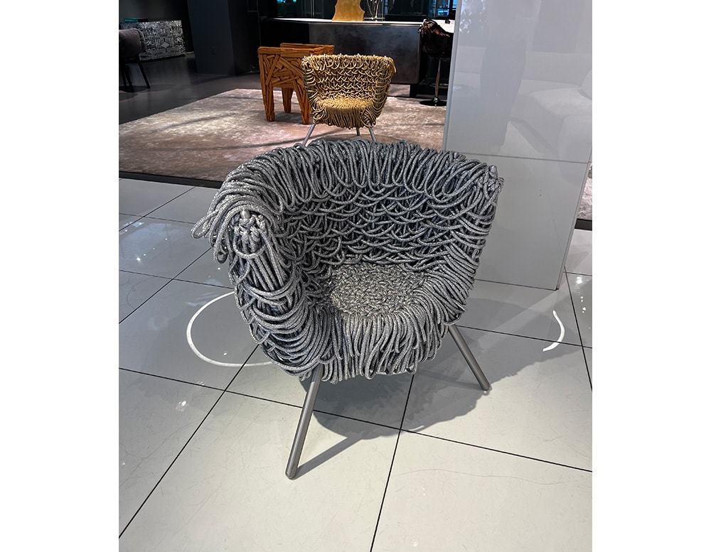 armchair made of acrylic, aluminum and silver-colored steel in a living room