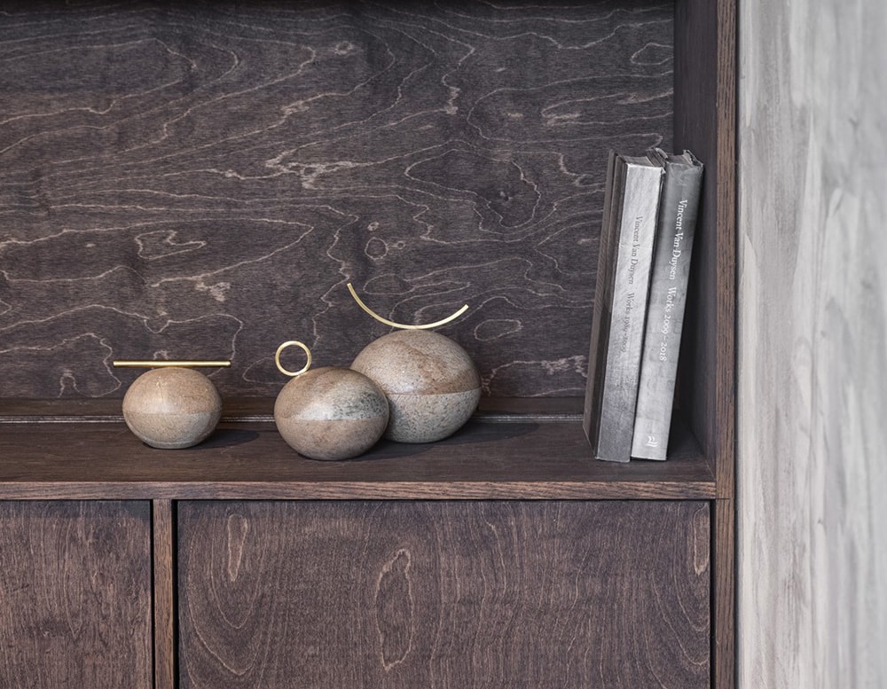 small gray soapstone vessels with brass finishes, used to store small precious objects such as jewelry.
