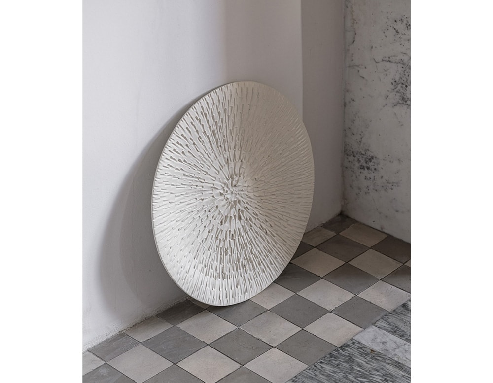 dish made from ceramic with a white tone and circular finishes.