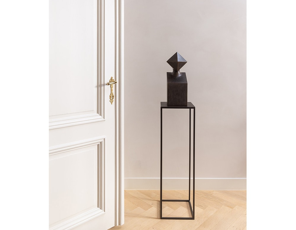small brown bronze sculpture in a room