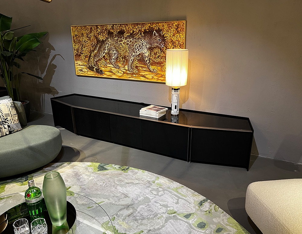 Black sideboard made of ash wood and a glossy black virio top with shiny metal finishes.