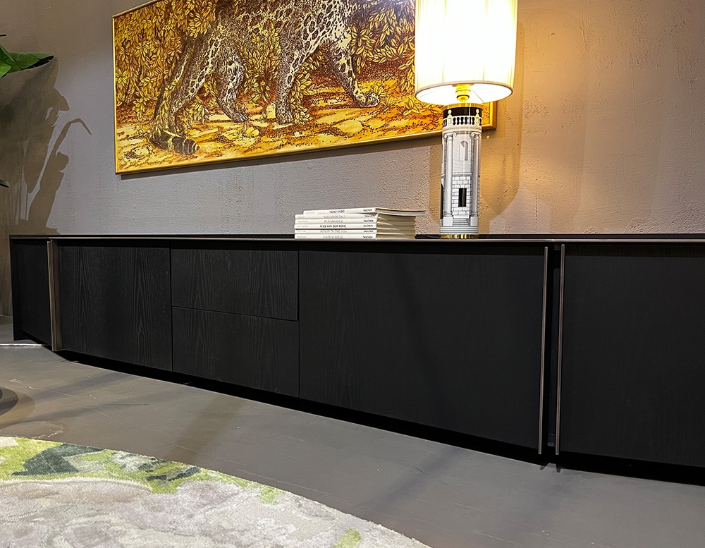 black sideboard with glass top and bronze lacquered metal finishes.