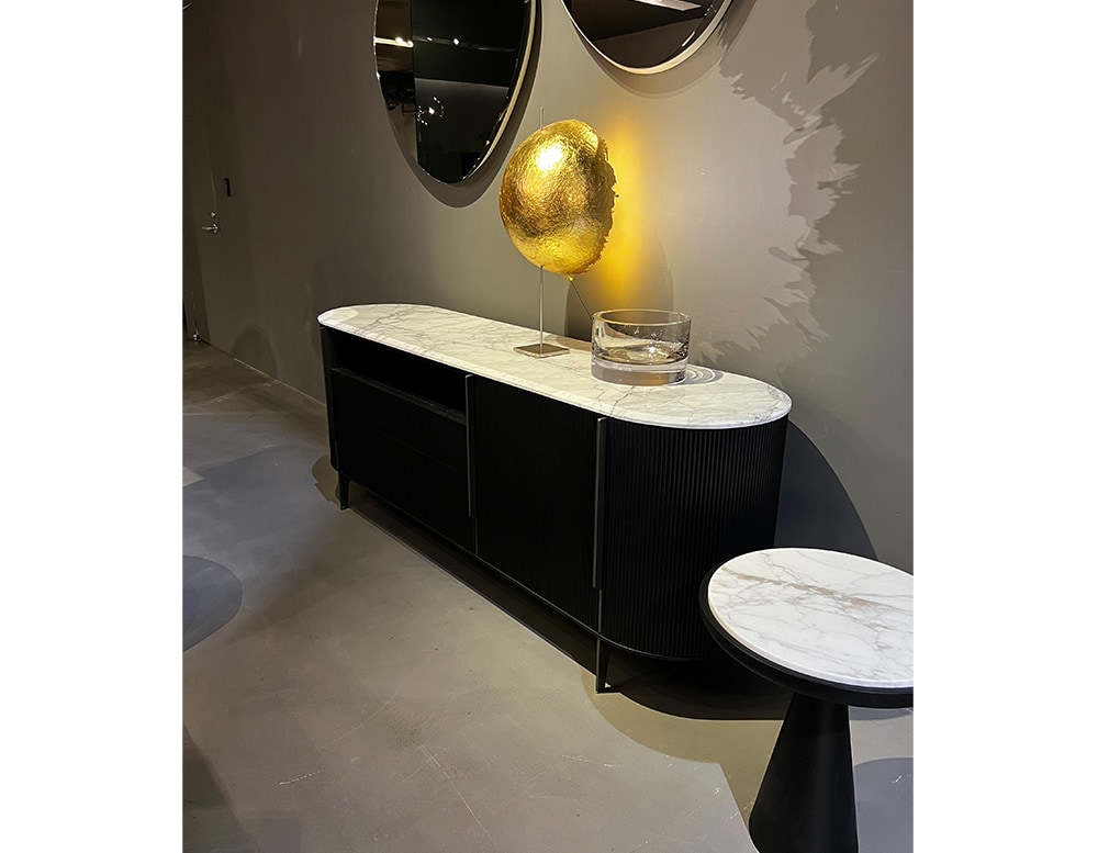 Black sideboard with doors, drawers and open module illuminated with yellow LED light.