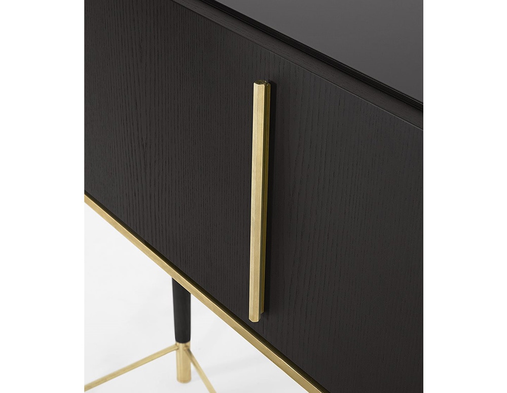 Writing desk with flap door in black wood with borders of satin brass lacquered metal parts