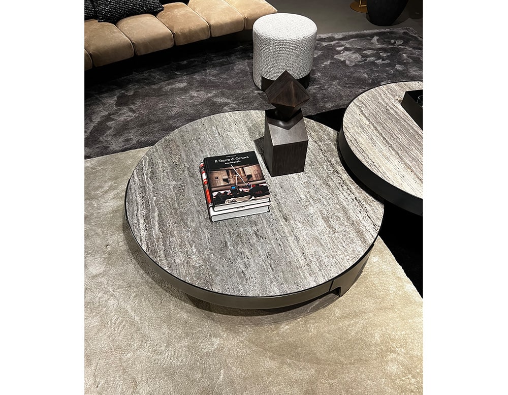 Star table with steel base and stone top in different shades of gray.