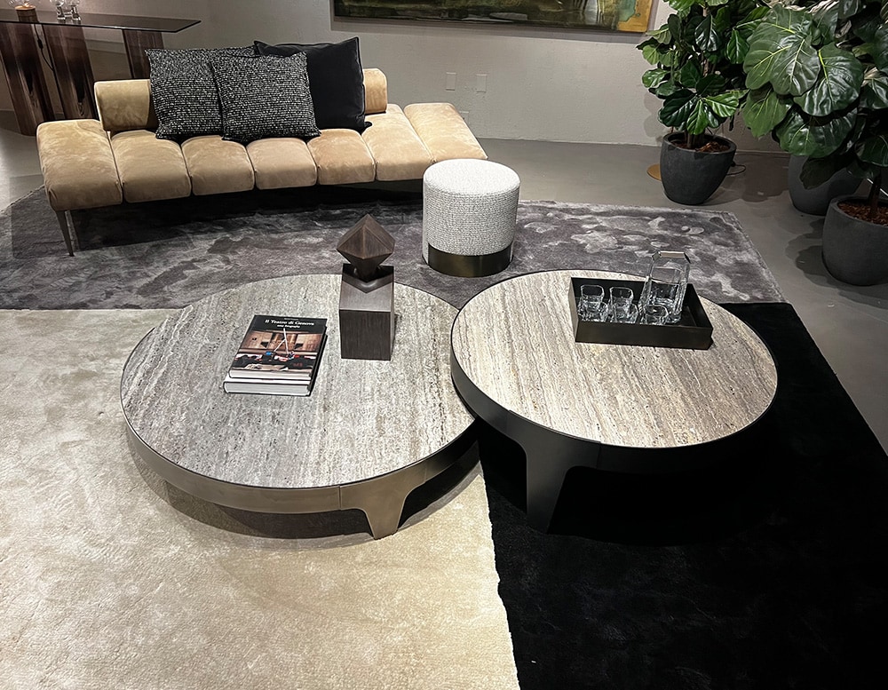 circular tables arranged in pairs made of stone and steel with different shades of gray colors.