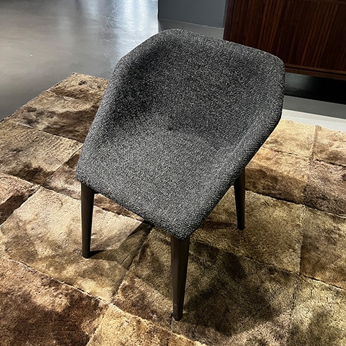 High quality handmade chair with gray and black fabric with a brown wooden base.