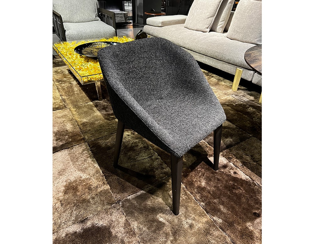 chair made of gray and black fabric with base made of brown wood.