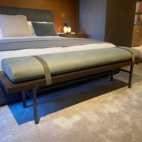 bed bench made of eucalyptus and upholstered in blue fabric and two leather straps