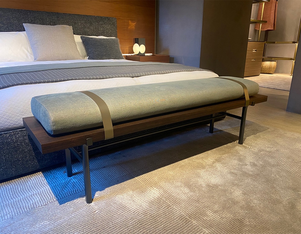 bed bench made of eucalyptus and upholstered in blue fabric and two leather straps