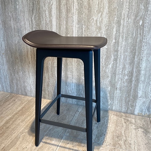 stool made from black lacquered ash wood and seat upholstered in brown leather