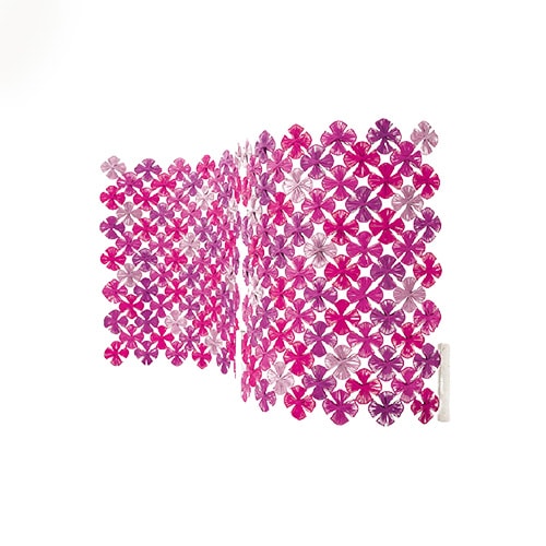 Lotus rug with flowers in different shades of pink with metal structure covered in rope yarn in a white background
