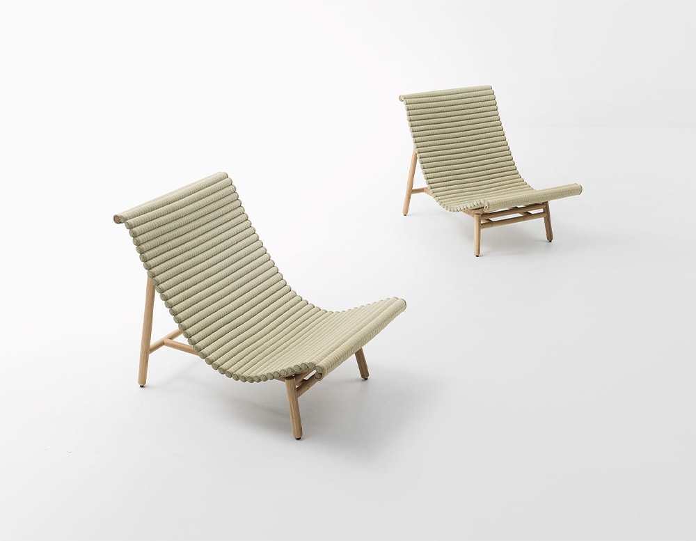 Two beige tatami lounge chairs, with wooden legs in a white background