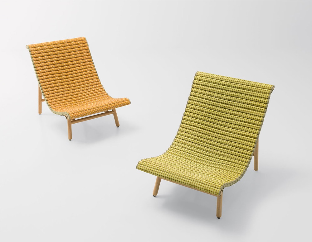 two tatami lounge chairs, one orange and the other green with clear wooden legs